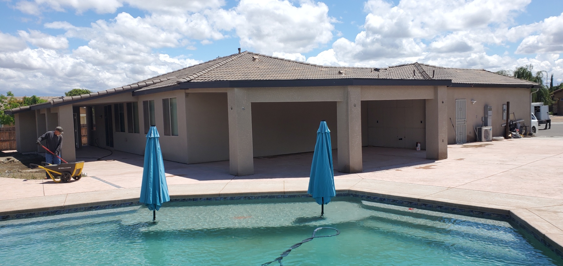 Single-story estate addition with tile roof, covered patio, and swimming pool by Panthera Construction